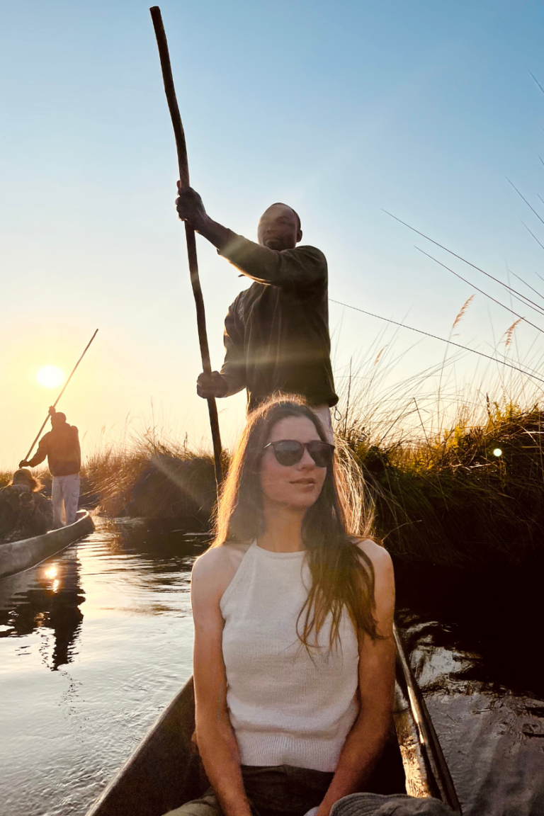 Woman taking a sunset cruise in the okovanga delta in Botswana