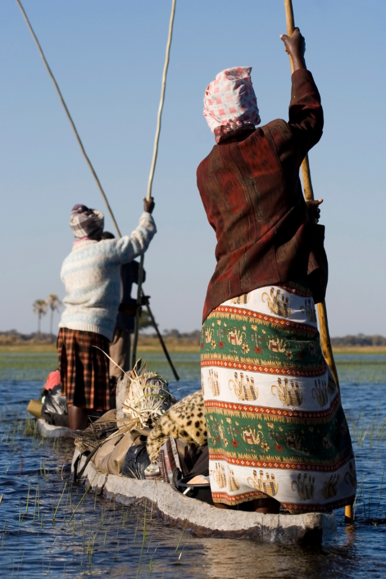 Botswana locals ons a Mokoro canoe in Botswana