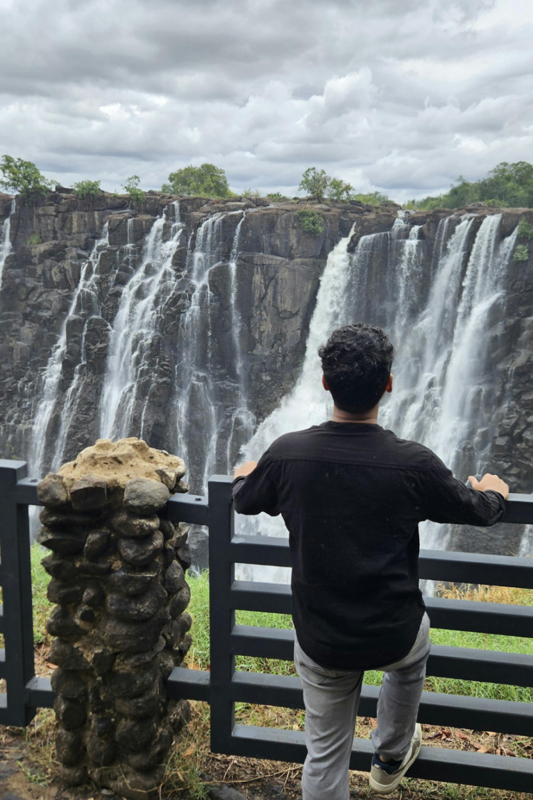 Tourist looking at the Victoria Falls in Zimbabwe